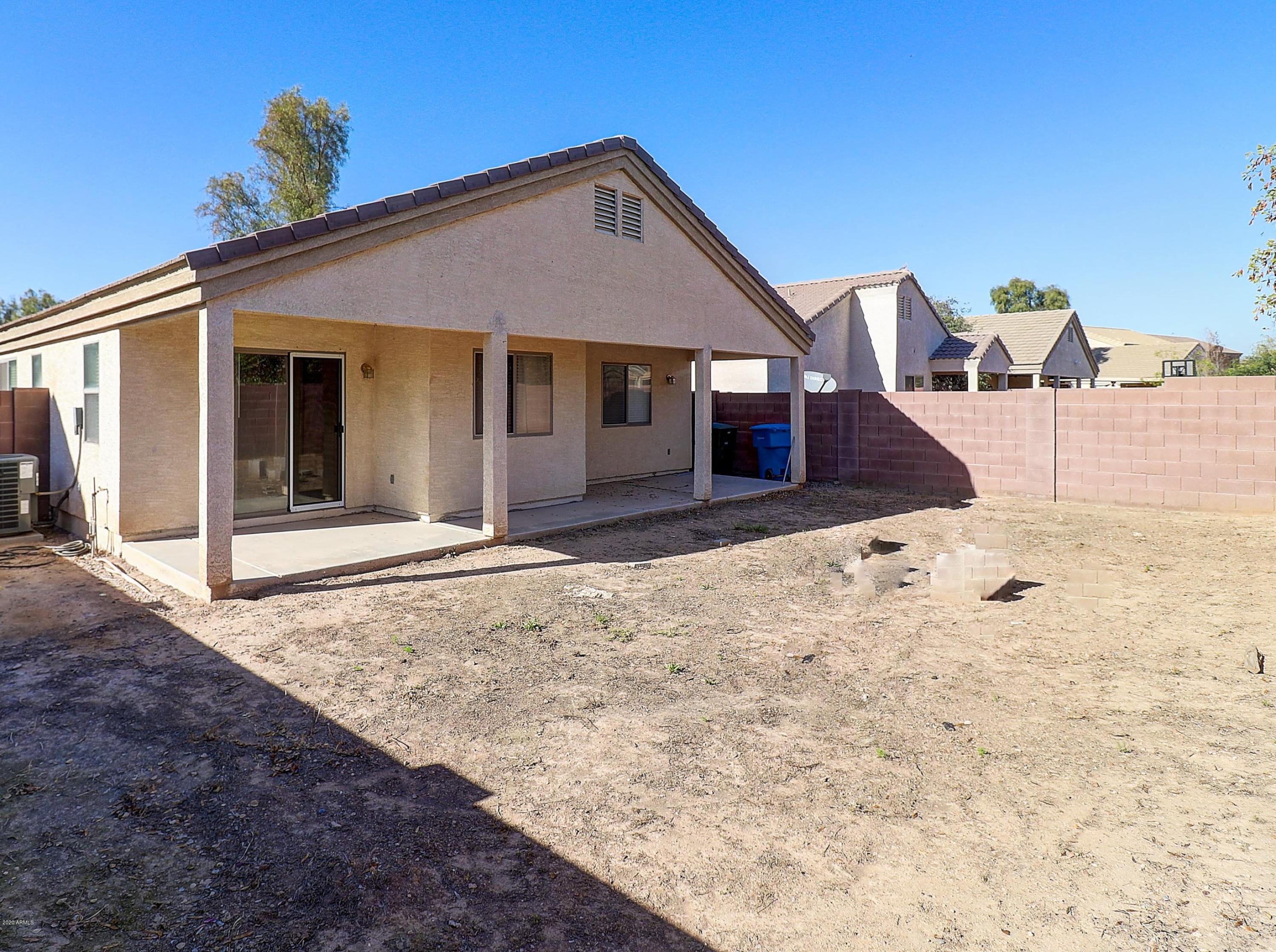 8461 West Riley Road Tolleson, AZ 85353 - Photo 25 of 25 a front view of a house with a yard