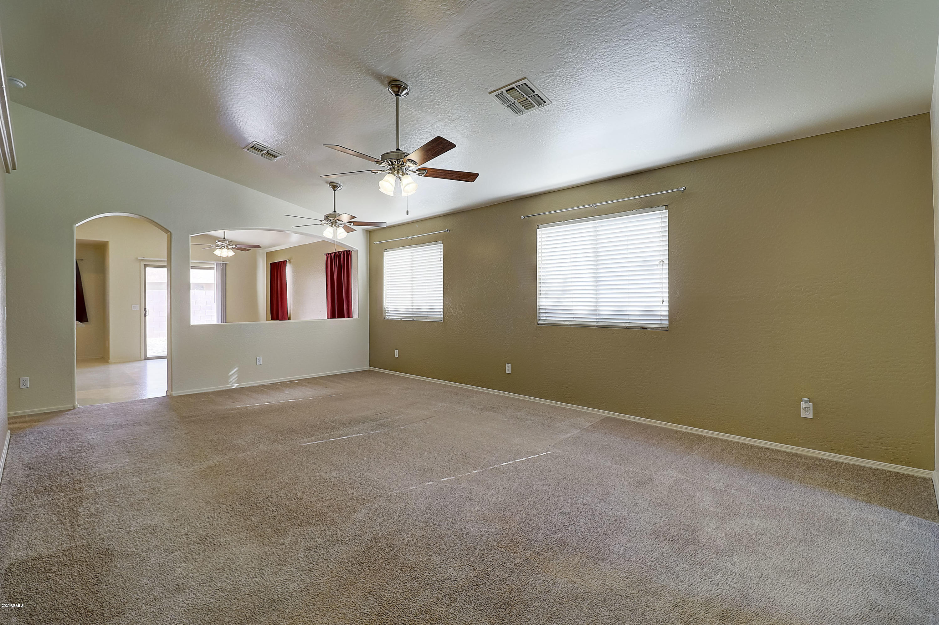 8461 West Riley Road Tolleson, AZ 85353 - Photo 3 of 25 an empty room with windows and ceiling fan view
