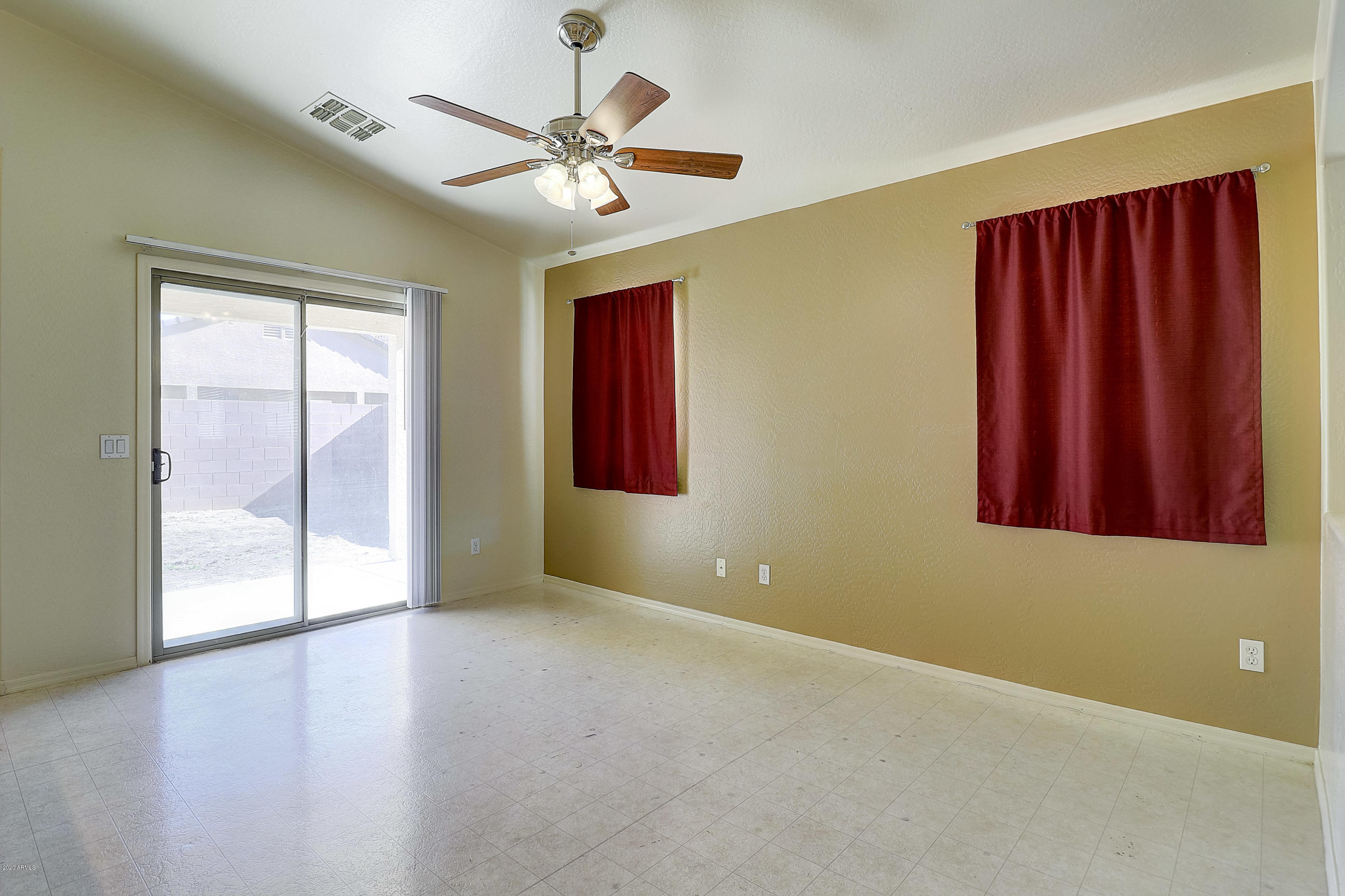 8461 West Riley Road Tolleson, AZ 85353 - Photo 9 of 25 an empty room with windows and fan