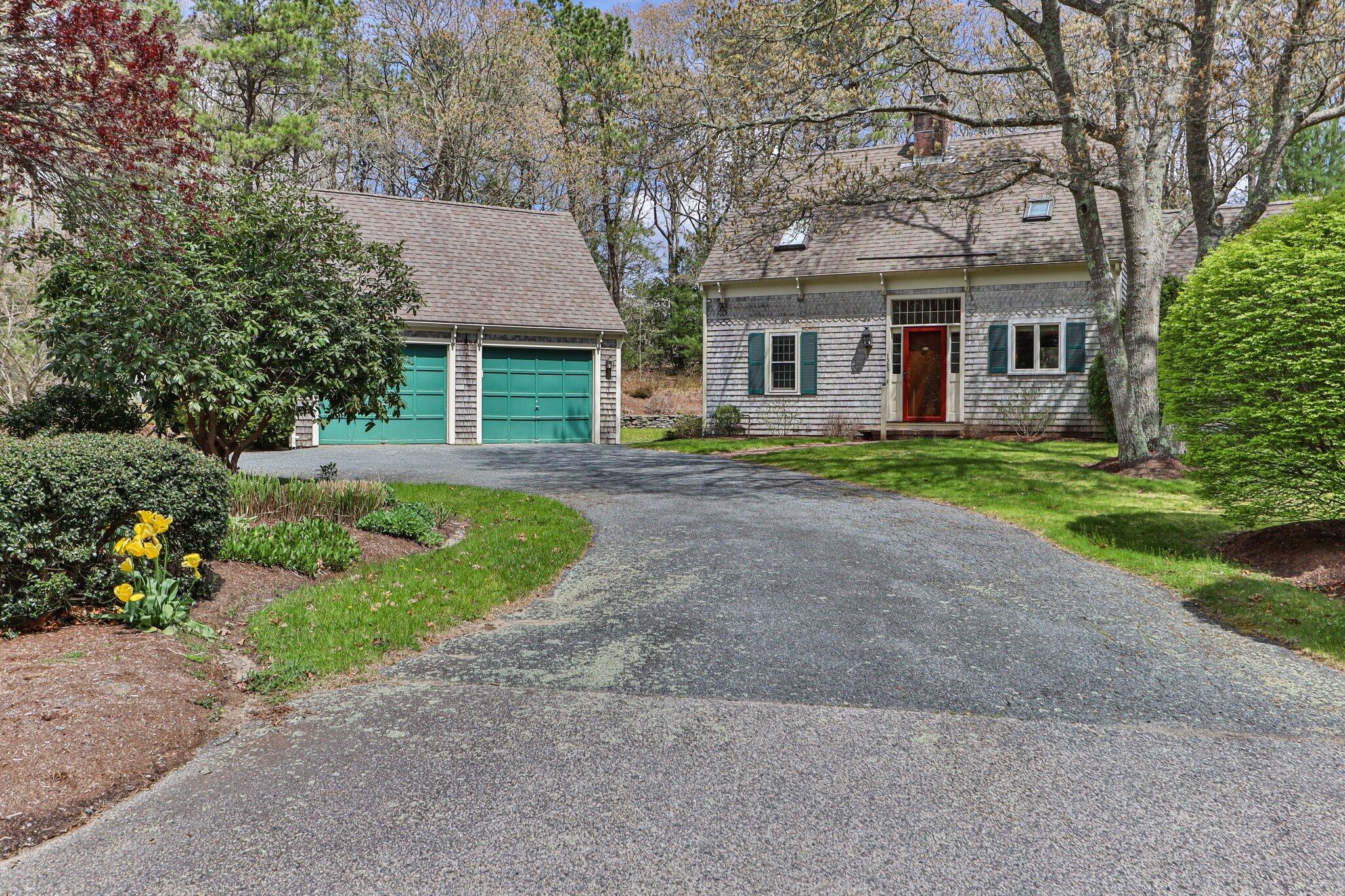 1363 Old Post Road Marstons Mills, MA 02648 - Photo 2 of 41 a front view of a house with a yard and trees
