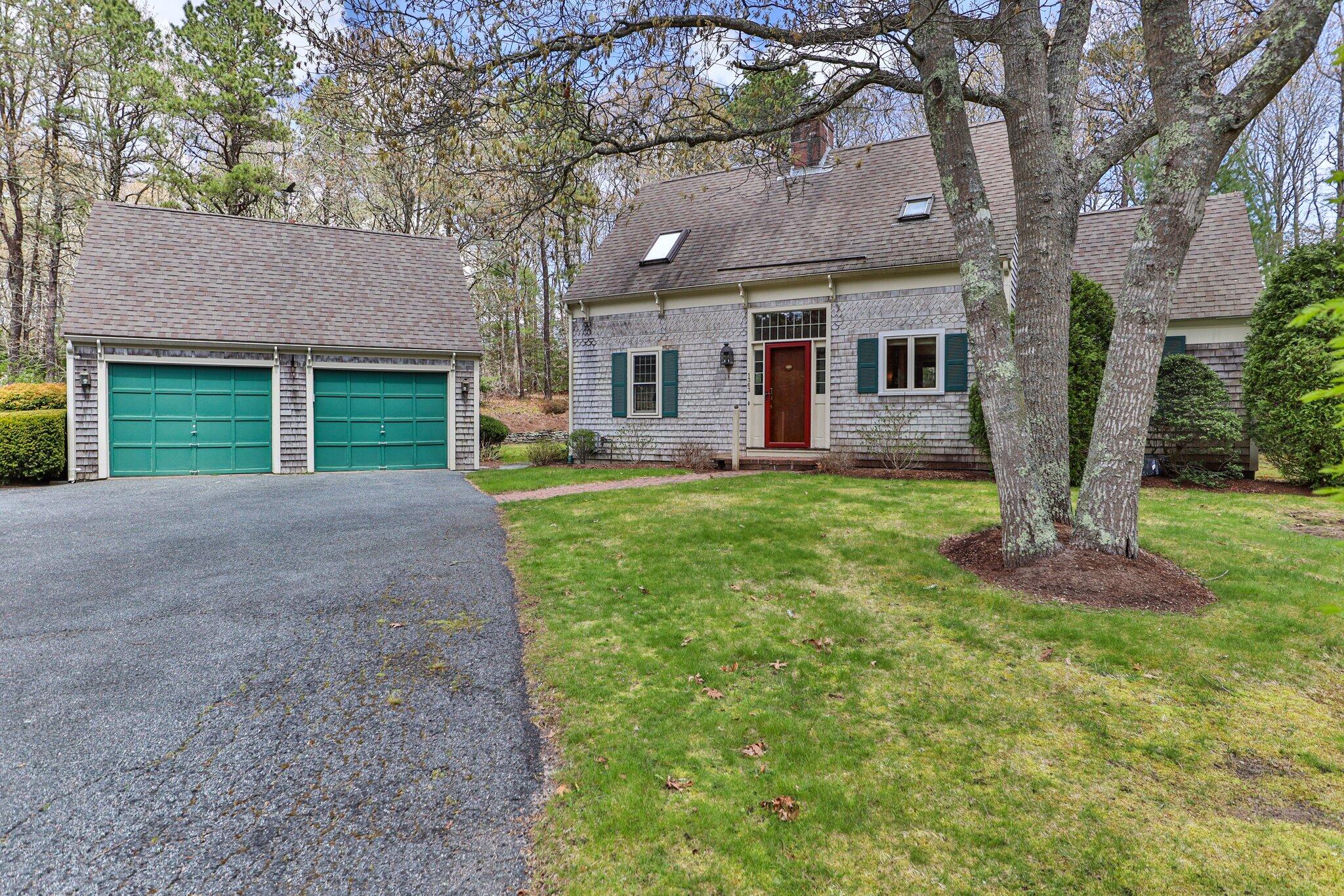 1363 Old Post Road Marstons Mills, MA 02648 - Photo 4 of 41 a front view of a house with a yard and garage