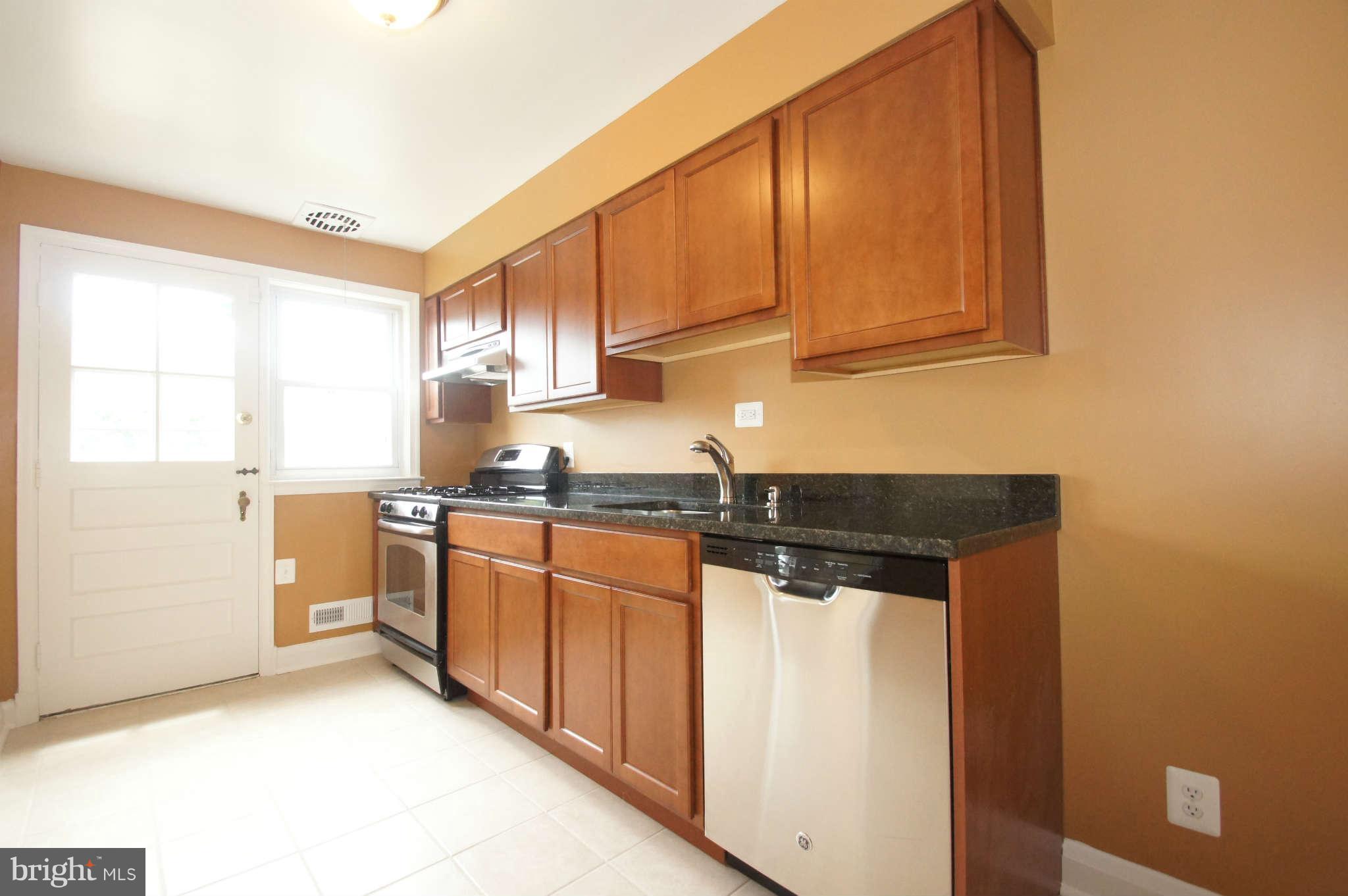 1423 Langford Road Baltimore, MD 21207 - Photo 11 of 30 a kitchen with stainless steel appliances granite countertop a sink a stove and a refrigerator