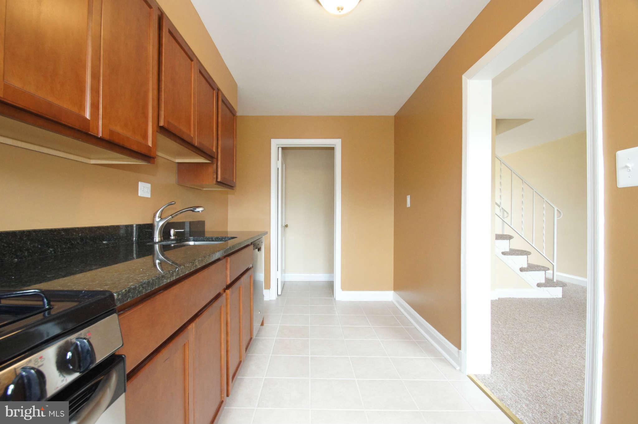 1423 Langford Road Baltimore, MD 21207 - Photo 14 of 30 a hallway with sink and cabinets
