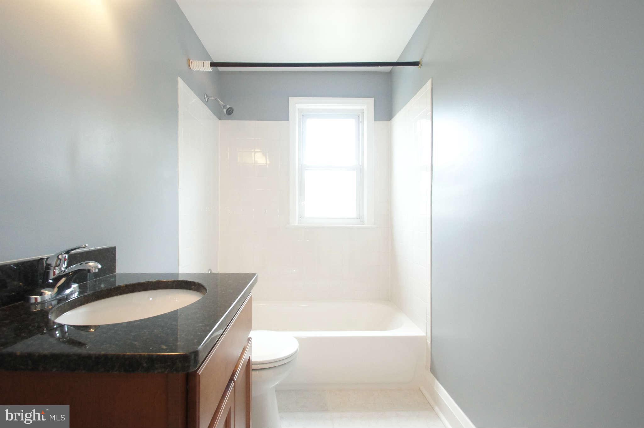 1423 Langford Road Baltimore, MD 21207 - Photo 24 of 30 a bathroom with a granite countertop sink toilet and shower