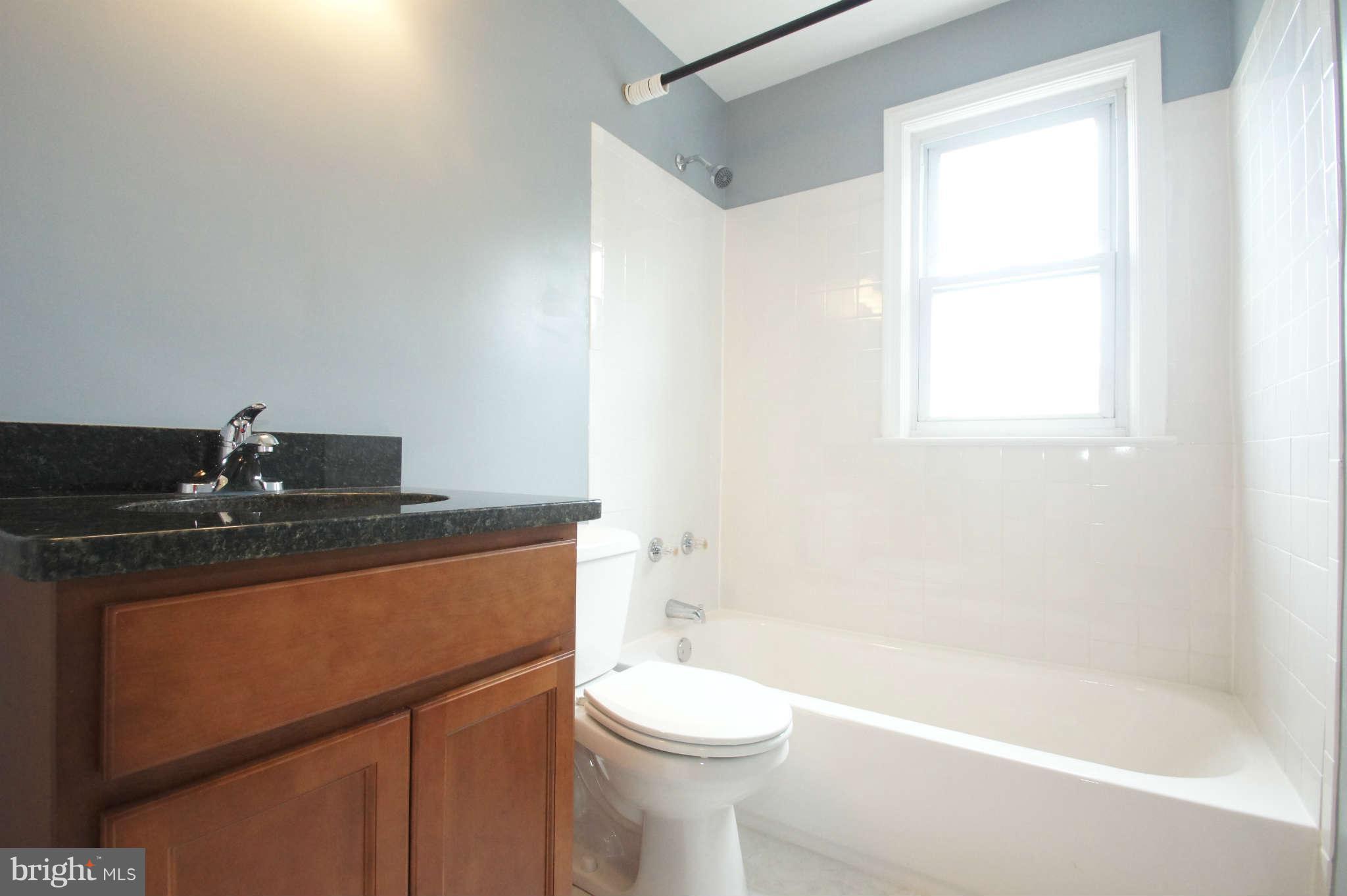 1423 Langford Road Baltimore, MD 21207 - Photo 25 of 30 a bathroom with a sink a toilet and a bathtub