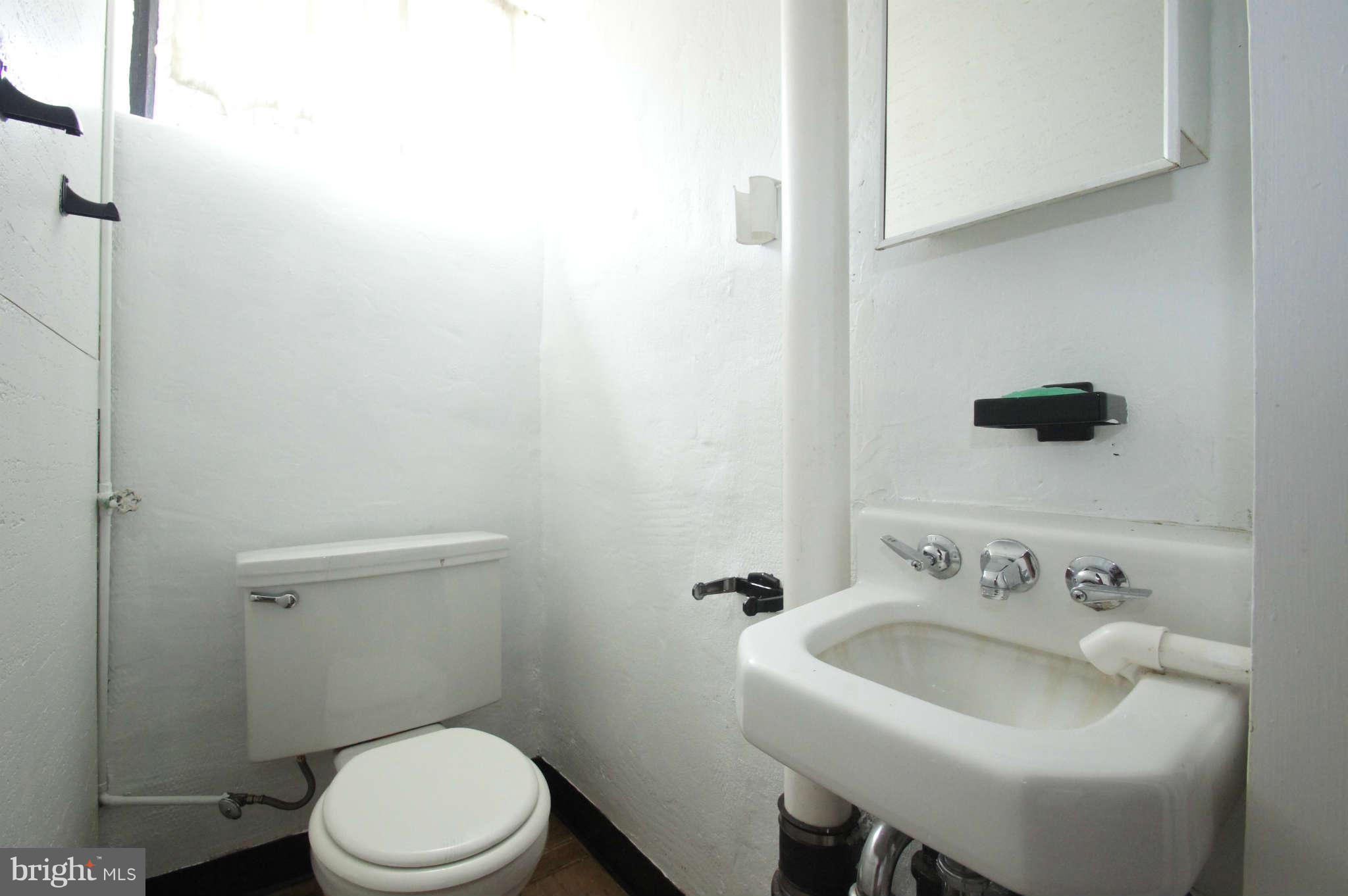 1423 Langford Road Baltimore, MD 21207 - Photo 26 of 30 a bathroom with a sink and a toilet