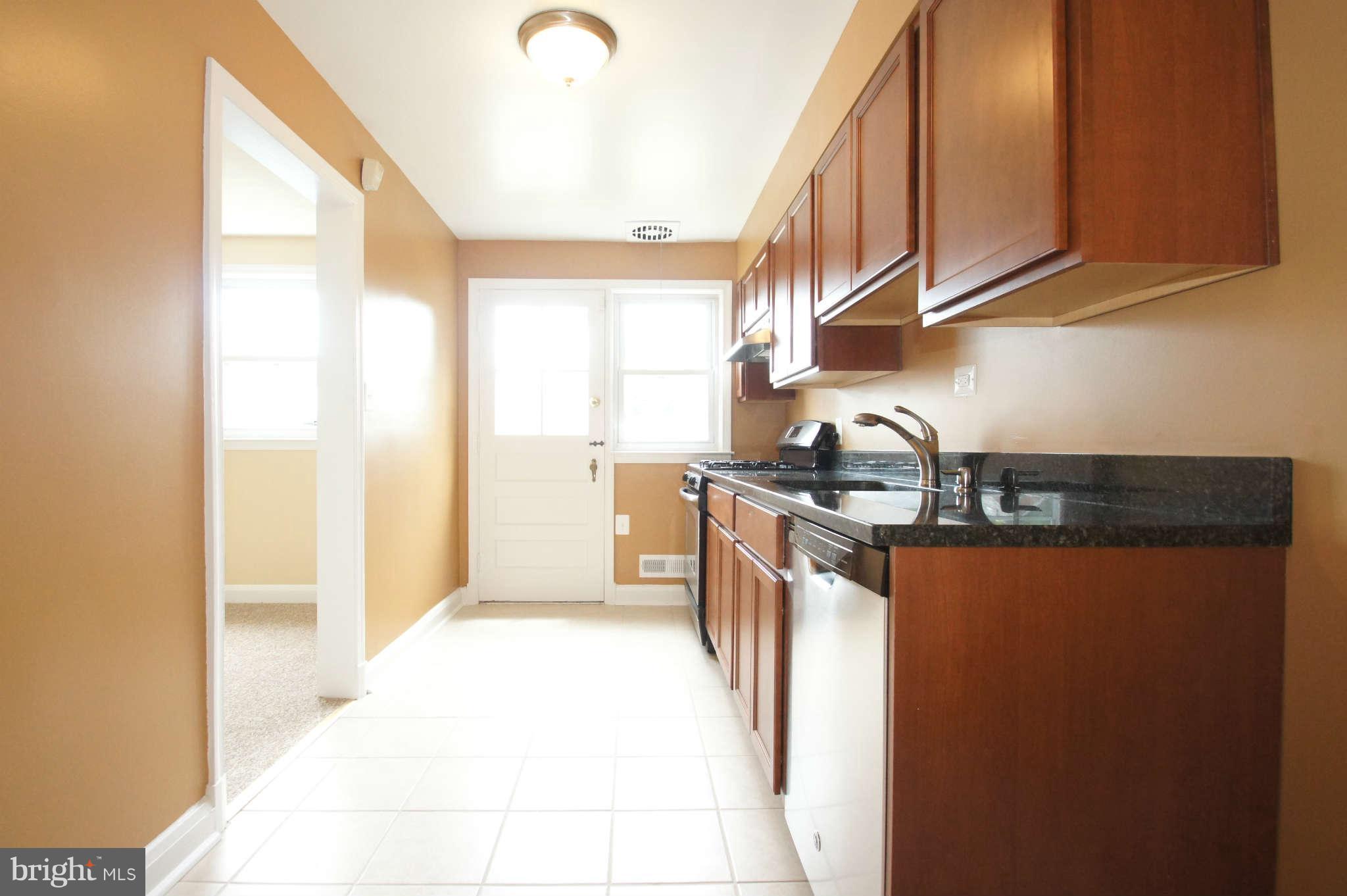 1423 Langford Road Baltimore, MD 21207 - Photo 10 of 30 a kitchen with stainless steel appliances granite countertop a stove a sink and a refrigerator