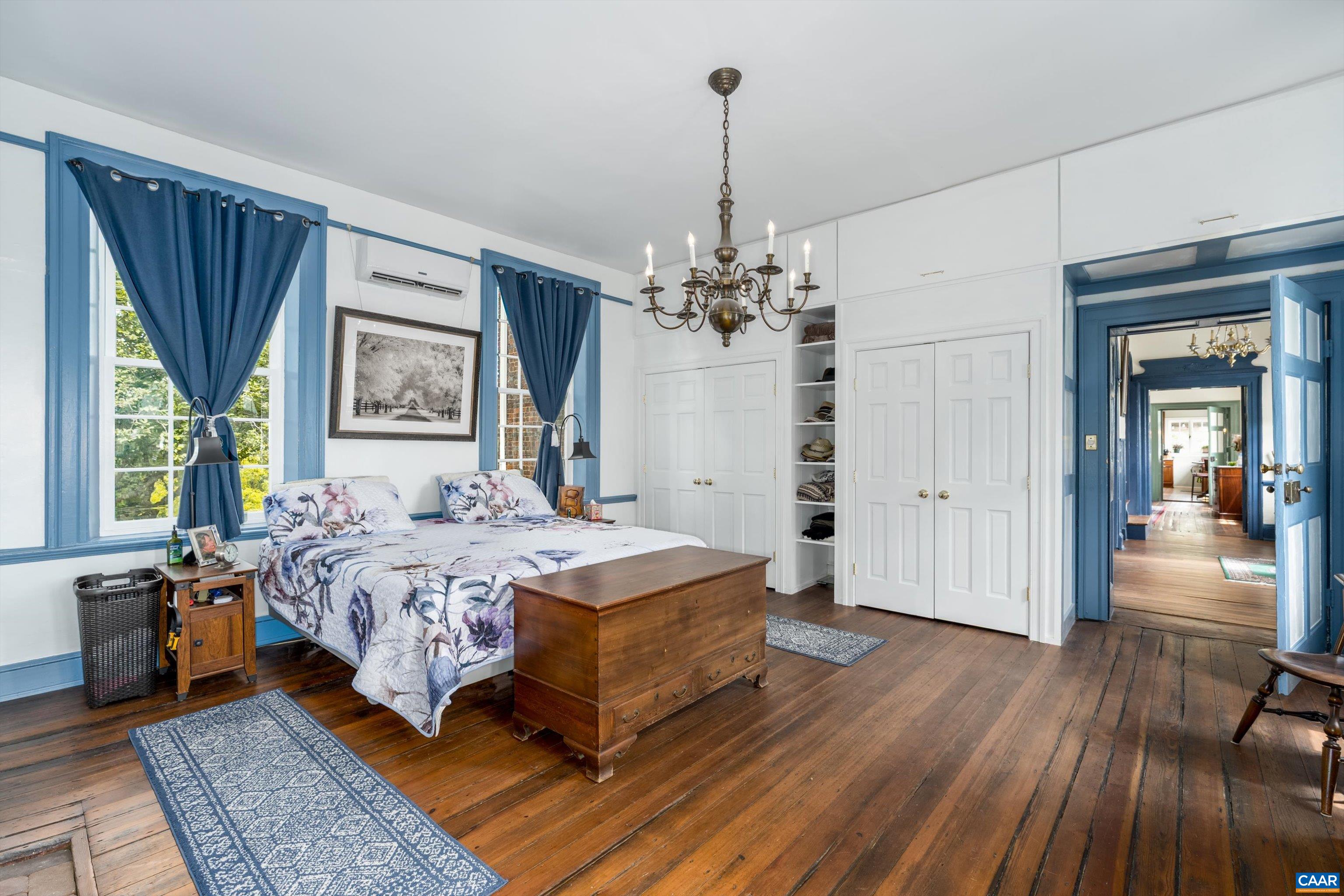 1843 Cabell Road Wingina, VA 24599 - Photo 27 of 74 a spacious bedroom with a bed and a chandelier