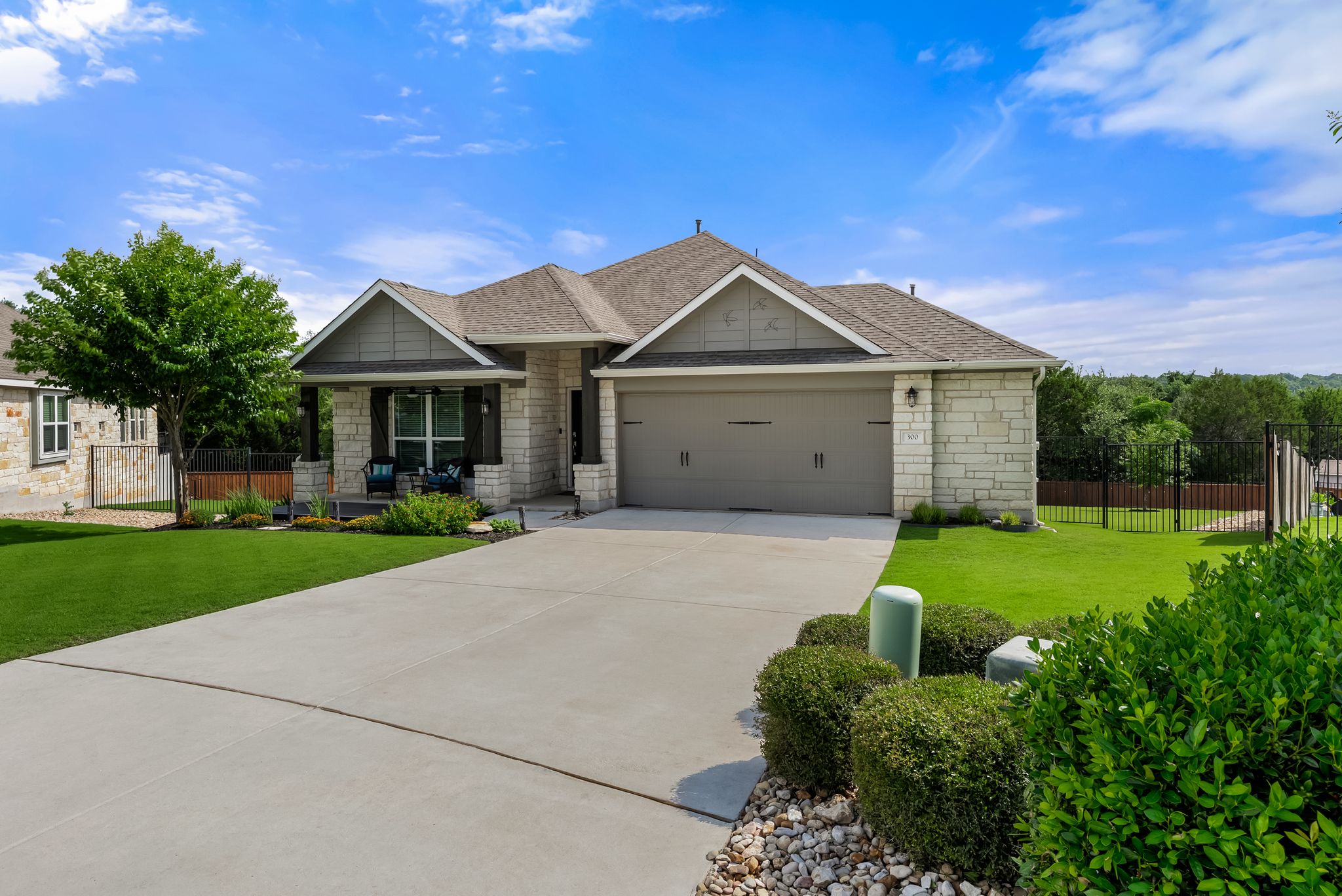 300 Prato Place Georgetown, TX 78628 - Photo 1 of 40 A welcoming stone and siding facade with a neat lawn and concrete driveway awaits.