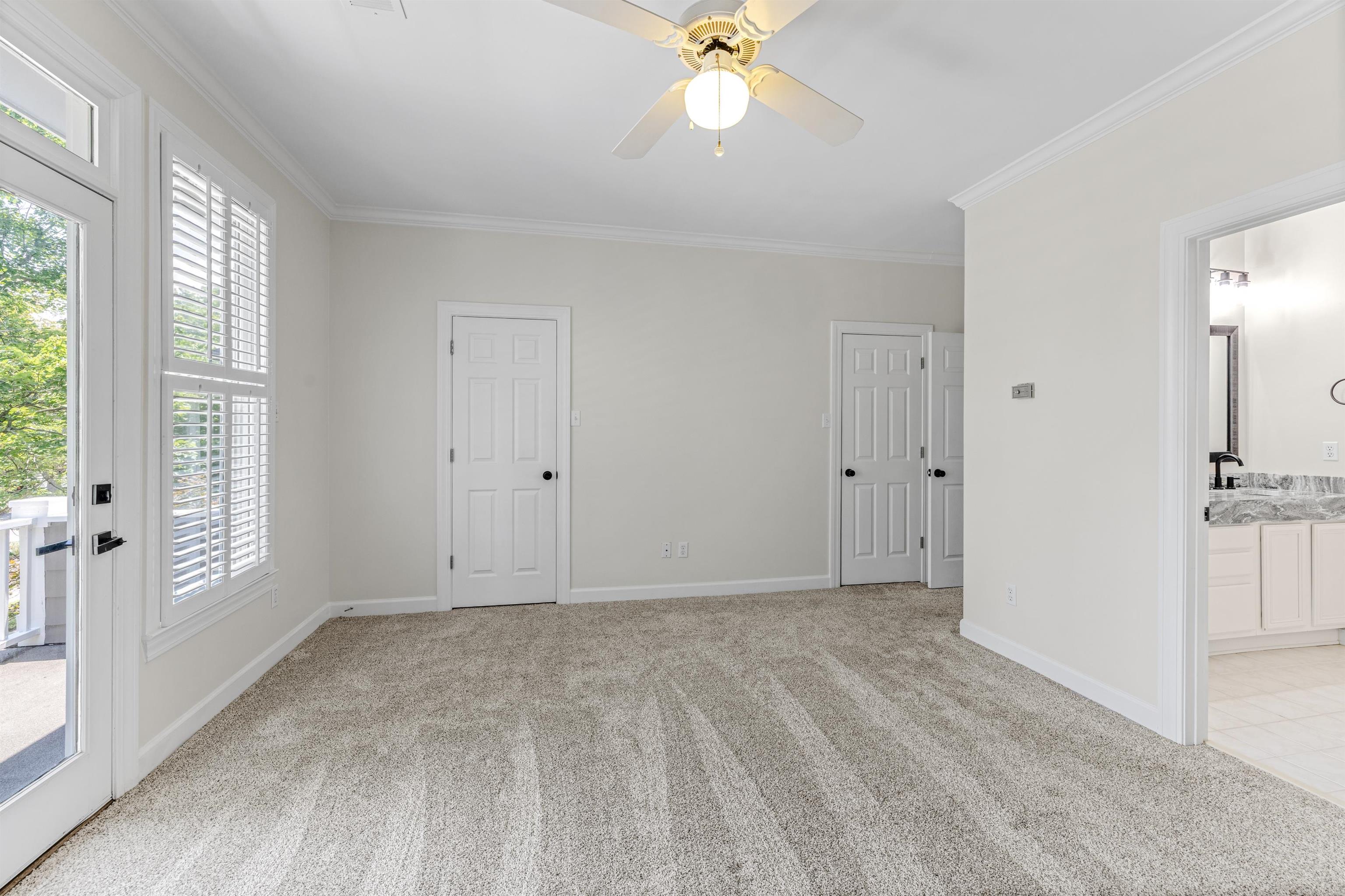 921 Harbor View Drive Memphis, TN 38103 - Photo 25 of 33 Carpeted room featuring a ceiling fan, white trim, and a glass-paneled door opening to an exterior balcony