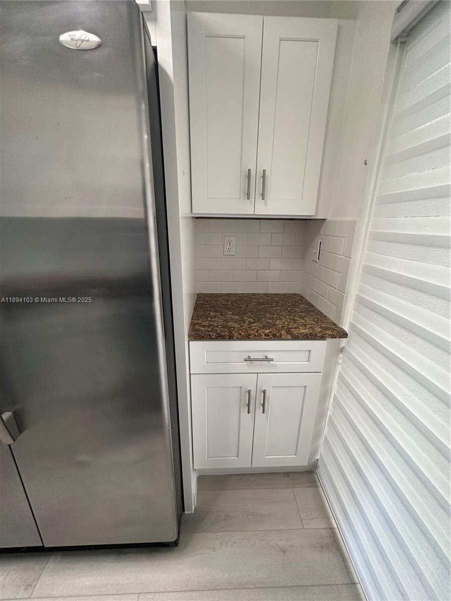 1852 Southwest 7th Street, Unit 109 Miami, FL 33135 - Photo 3 of 21 a kitchen with white cabinets and a stove