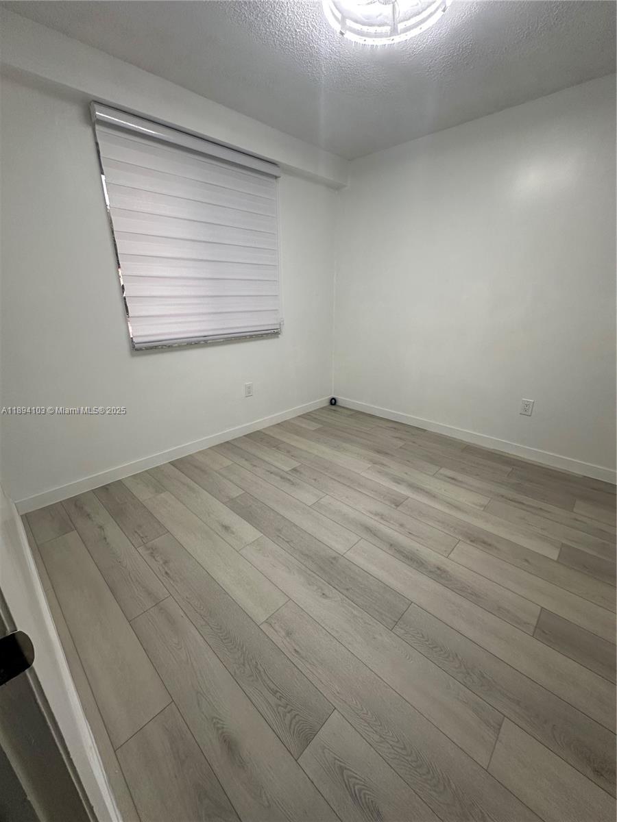 1852 Southwest 7th Street, Unit 109 Miami, FL 33135 - Photo 9 of 21 an empty room with windows