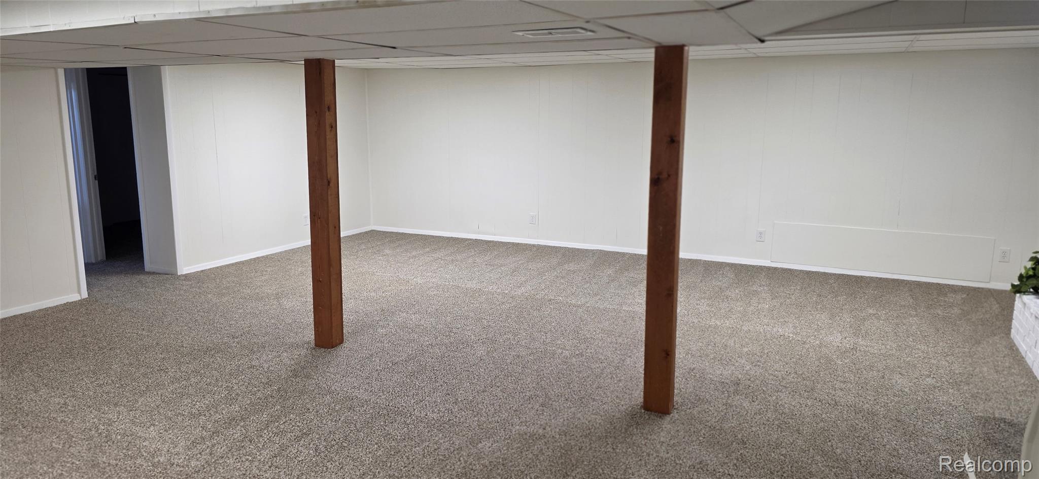 4363 West Dodge Road Clio, MI 48420 - Photo 36 of 52 Spacious finished lower level featuring wall-to-wall carpeting, white paneling, and a drop ceiling