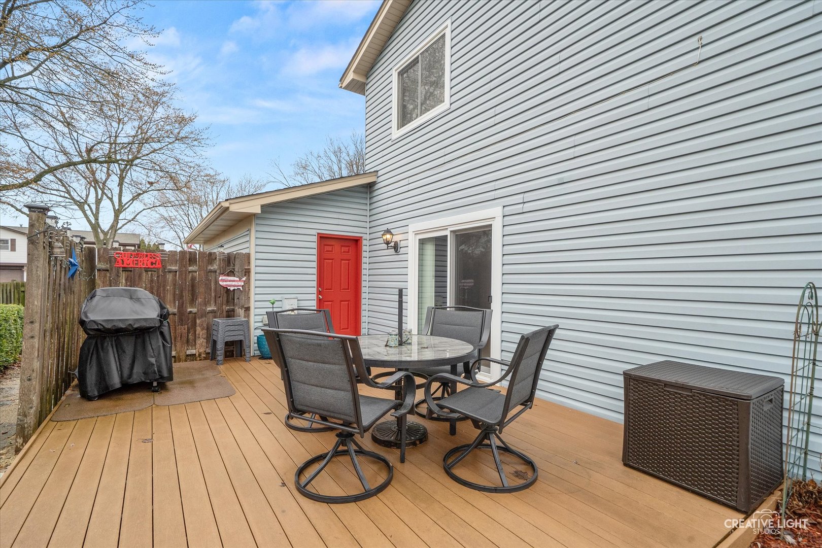 420 Quarry Drive Bolingbrook, IL 60490 - Photo 22 of 28 a view of a patio with table and chairs with wooden floor and fence
