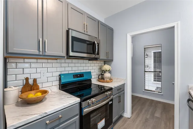 a kitchen with a sink a stove and cabinets