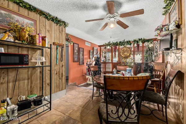 a dining room with furniture and a floor to ceiling window