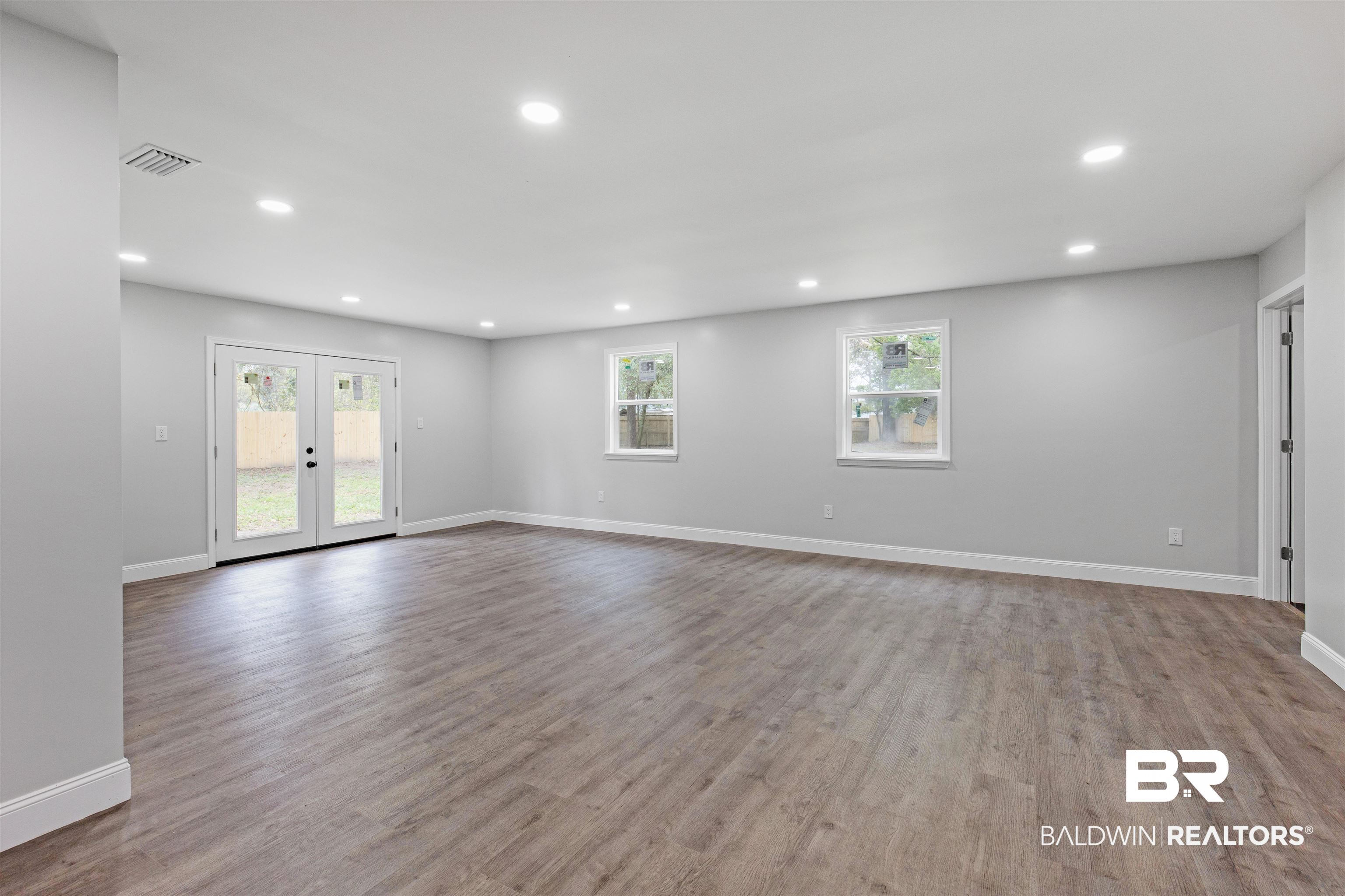 1432 South Polaris Drive Mobile, AL 36693 - Photo 14 of 27 Empty room featuring recessed lighting, wood finished floors, and french doors