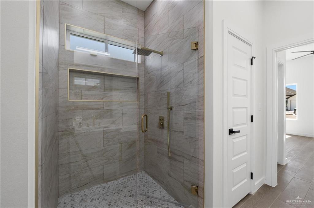 505 Freedom Way Weslaco, TX 78596 - Photo 10 of 20 a bathroom with a glass shower door