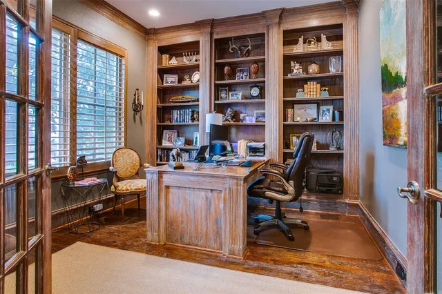 a view of a workspace with furniture and a bookshelf