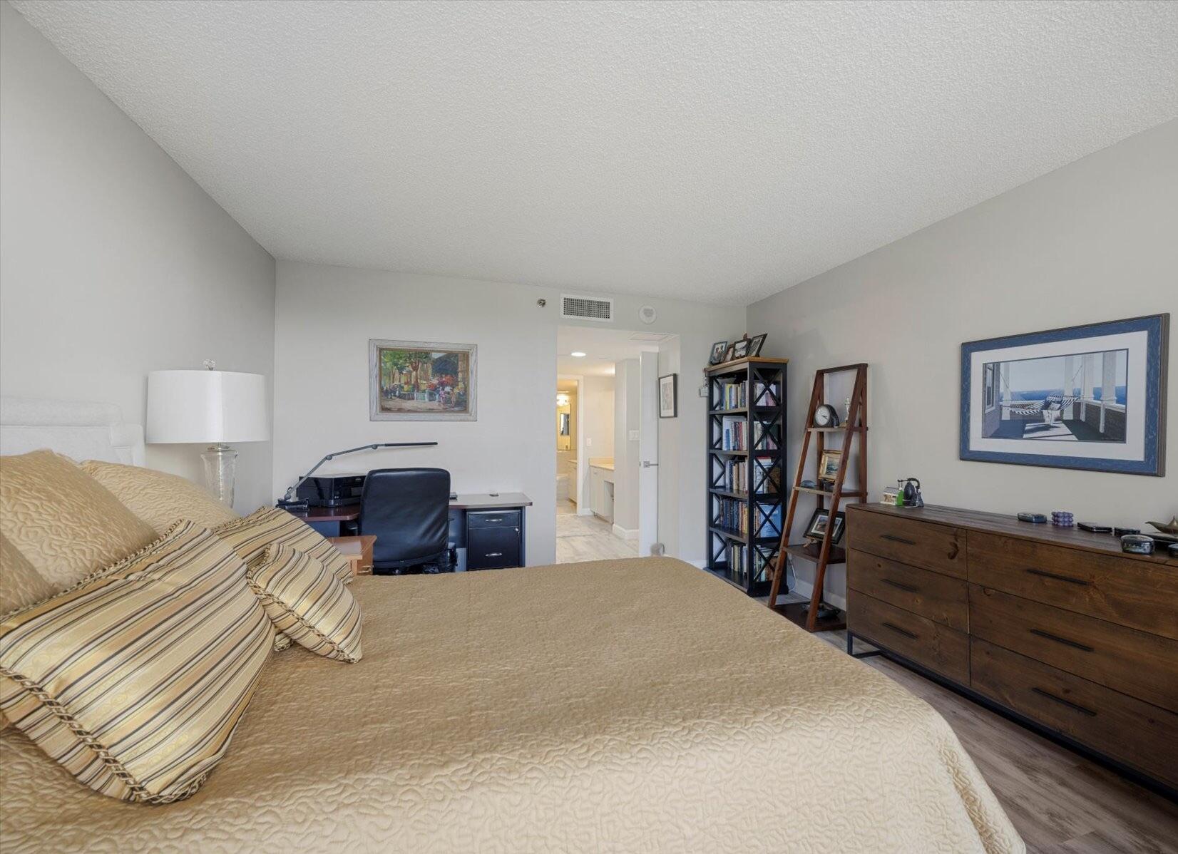 4101 North Ocean Boulevard, Unit 308 Boca Raton, FL 33431 - Photo 12 of 23 a bedroom with a large bed and a chandelier