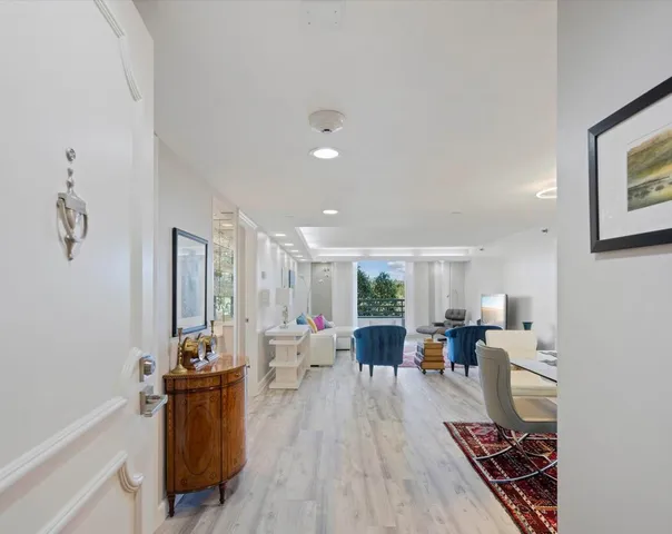 a living room with furniture appliances and wooden floor