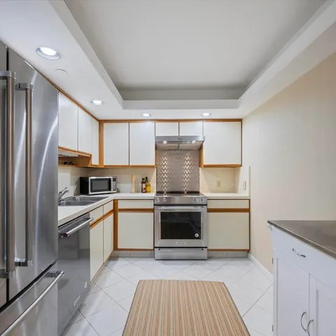 a kitchen with stainless steel appliances granite countertop a stove and a refrigerator