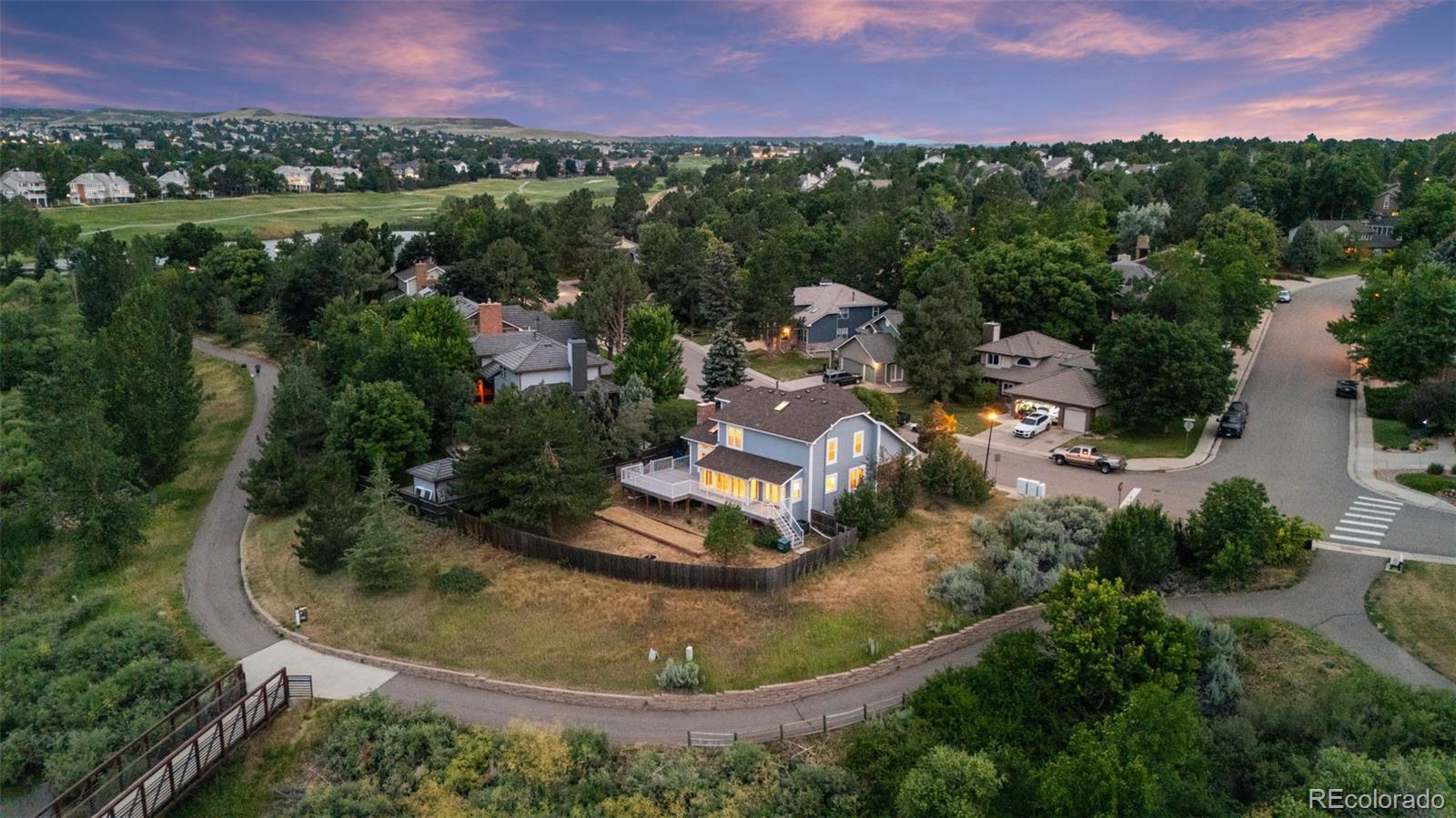 an aerial view of a house with a yard and lake view