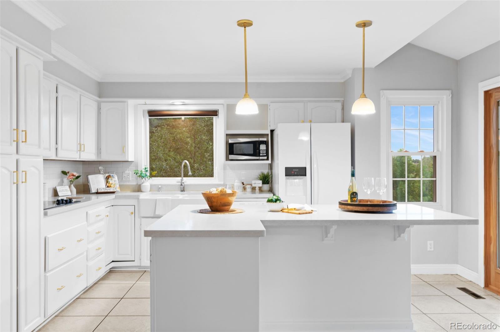 8385 Sweet Water Road Lone Tree, CO 80124 - Photo 11 of 50 a kitchen with sink cabinets and window