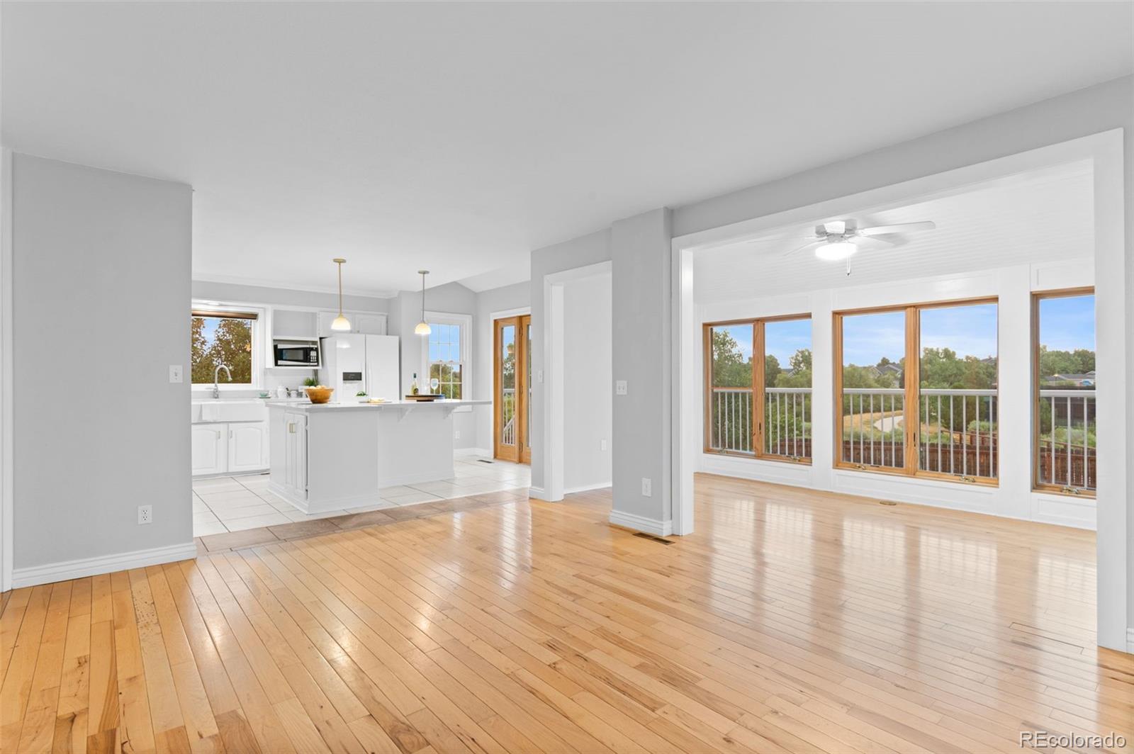 8385 Sweet Water Road Lone Tree, CO 80124 - Photo 14 of 50 a view of an empty room with wooden floor and a window