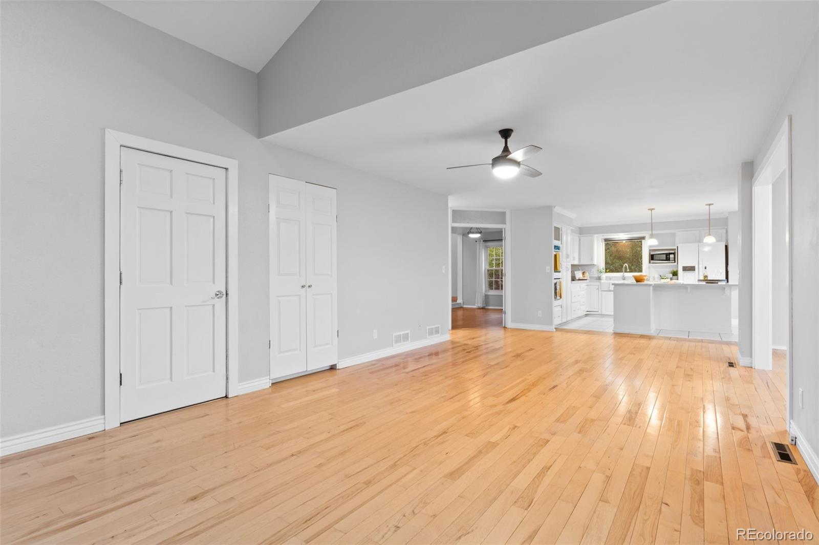 8385 Sweet Water Road Lone Tree, CO 80124 - Photo 19 of 50 a view of a kitchen with wooden floor and a ceiling fan