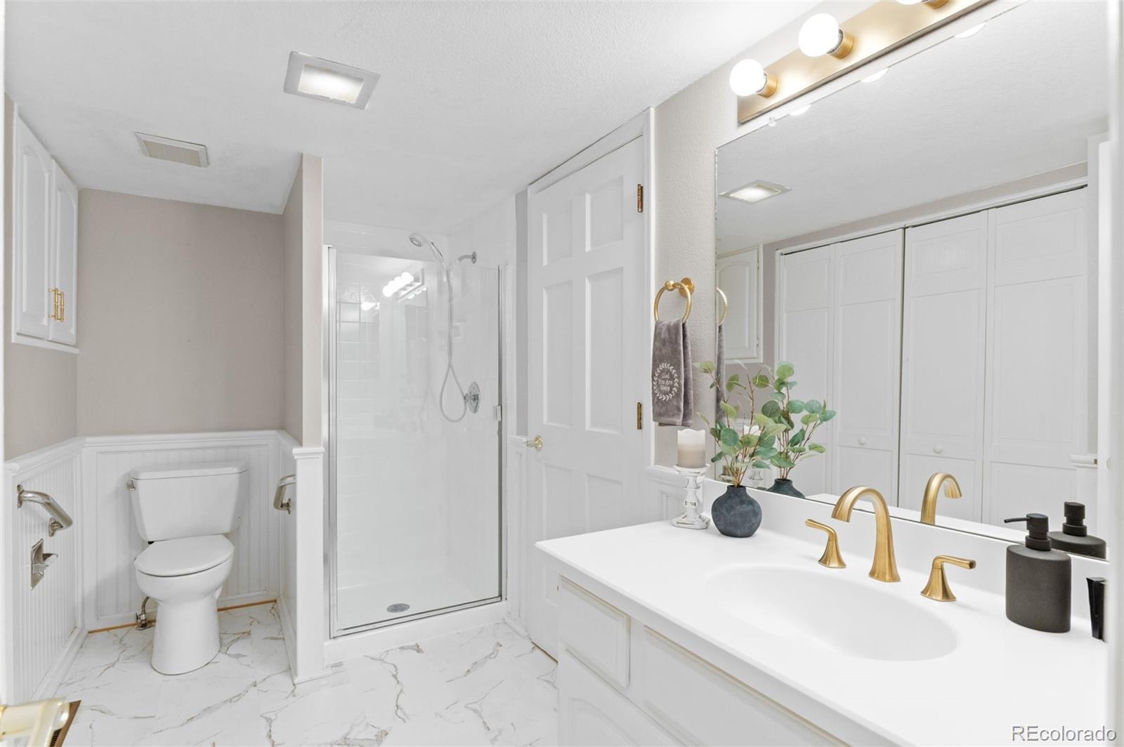 8385 Sweet Water Road Lone Tree, CO 80124 - Photo 20 of 50 a bathroom with a sink toilet and shower