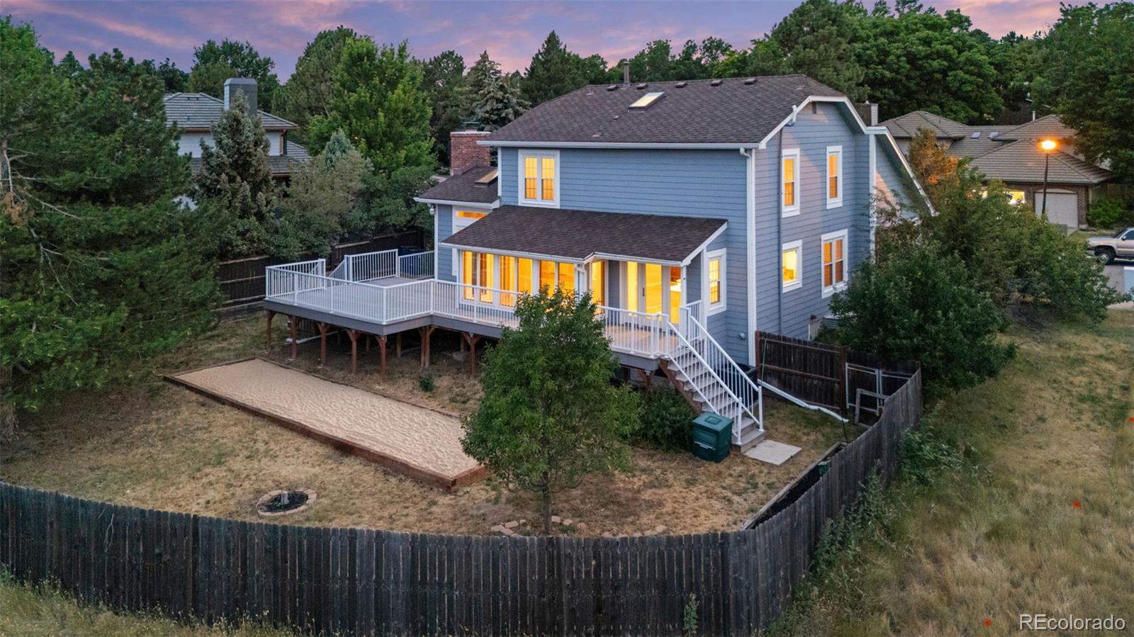 8385 Sweet Water Road Lone Tree, CO 80124 - Photo 2 of 50 a view of a backyard with table and chairs with wooden fence