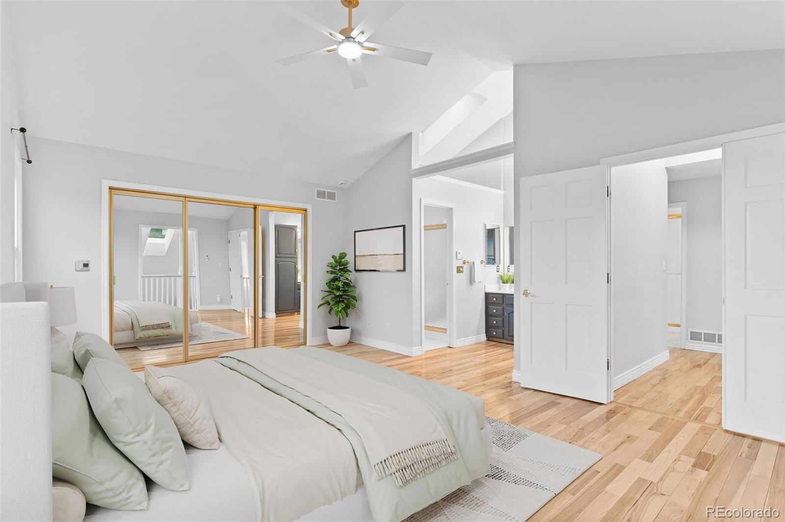 8385 Sweet Water Road Lone Tree, CO 80124 - Photo 22 of 50 a bedroom with a large bed and chandelier