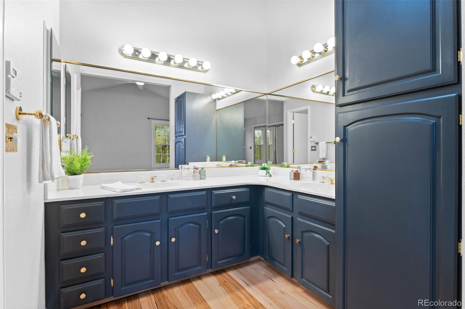 8385 Sweet Water Road Lone Tree, CO 80124 - Photo 25 of 50 a spacious bathroom with a double vanity sink and a mirror