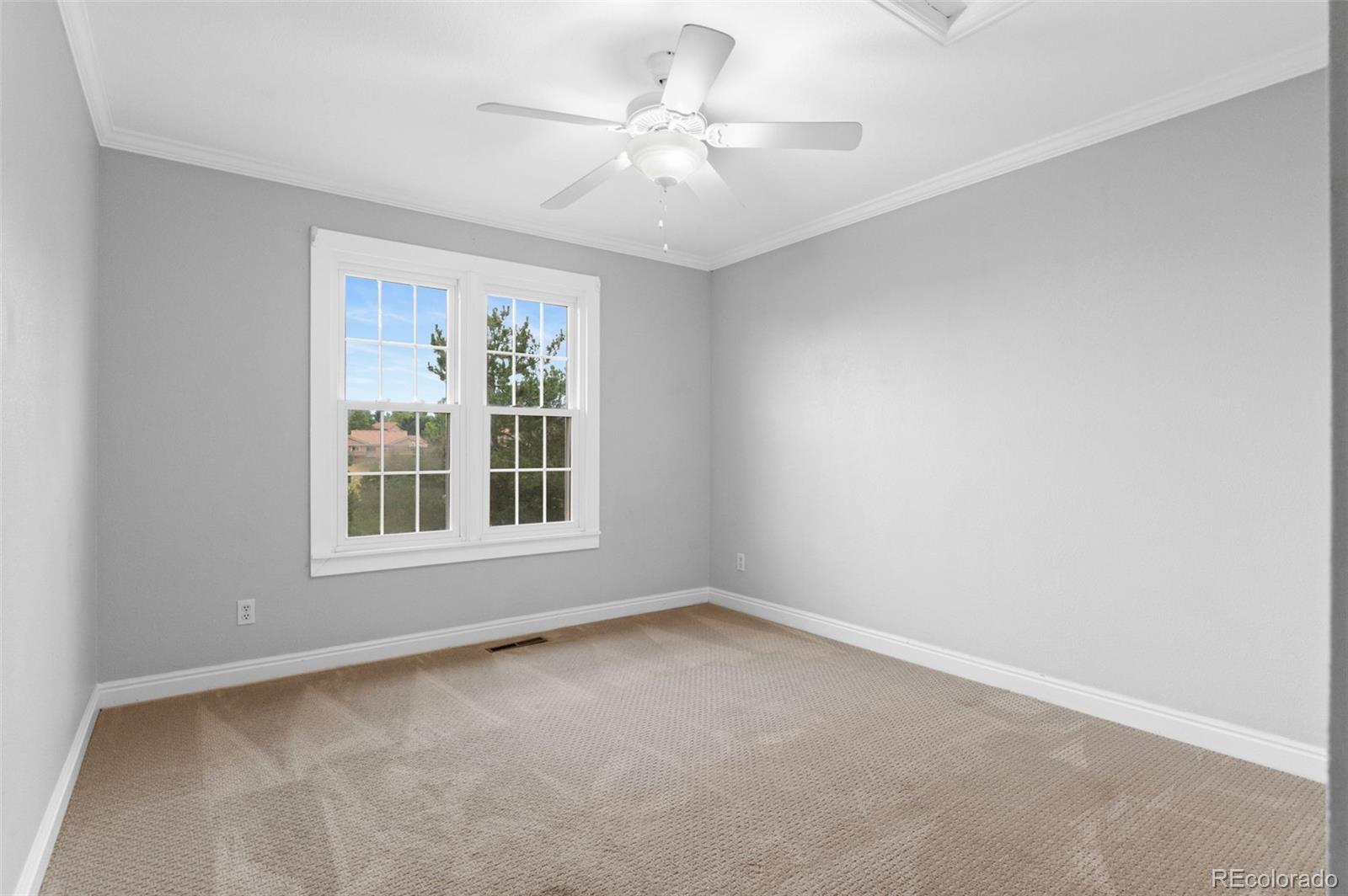 8385 Sweet Water Road Lone Tree, CO 80124 - Photo 28 of 50 an empty room with a window and a ceiling fan