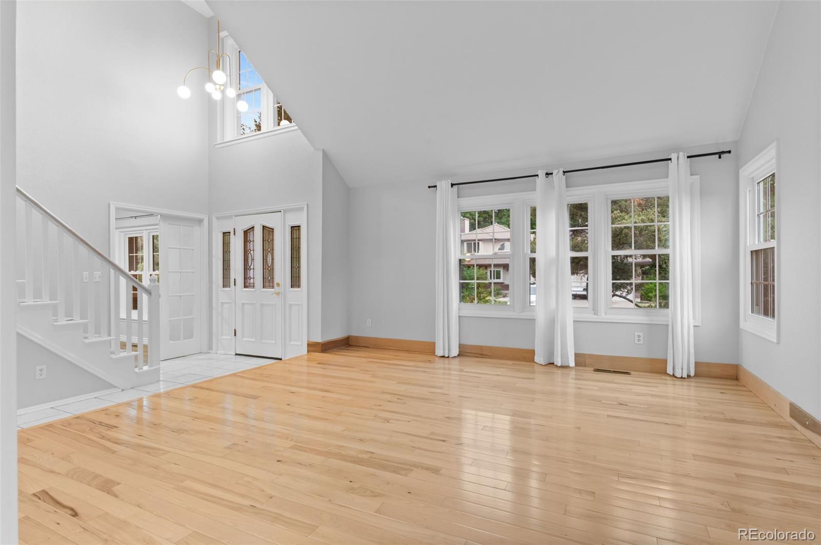 8385 Sweet Water Road Lone Tree, CO 80124 - Photo 7 of 50 a view of empty room with wooden floor and fan