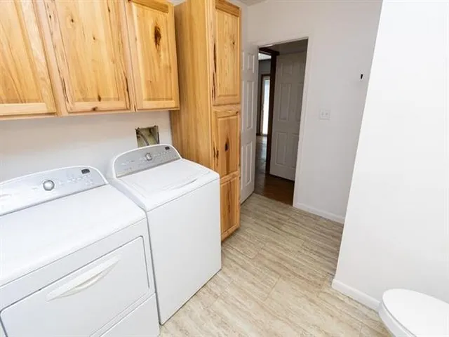 a view of storage and utility room with washer and dryer