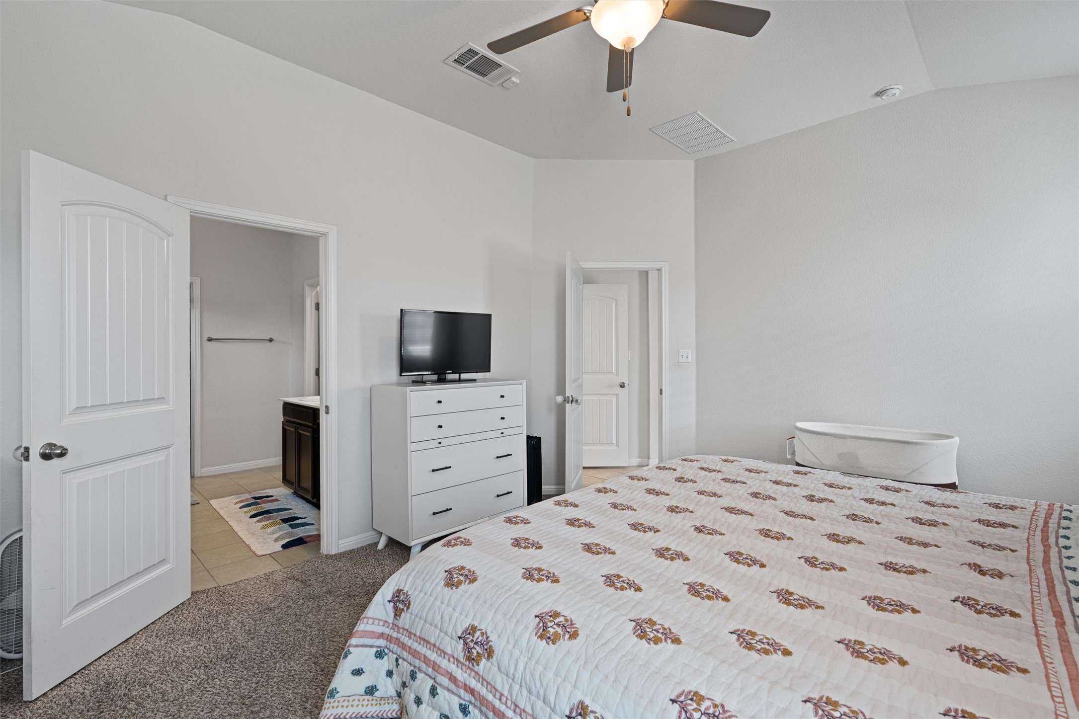 137 Red Sun Drive Kyle, TX 78640 - Photo 13 of 38 a bedroom with a bed and a flat screen tv