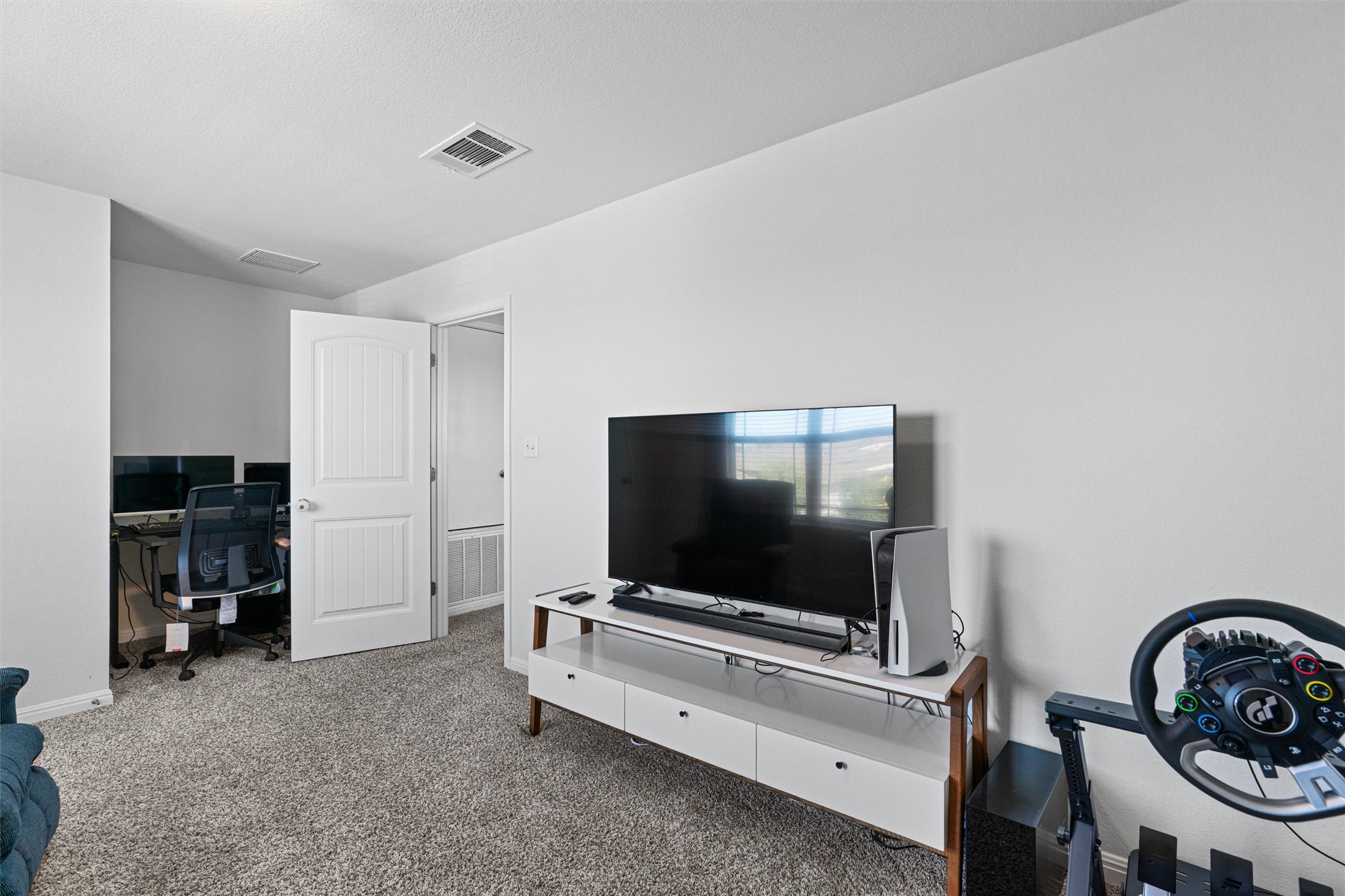 137 Red Sun Drive Kyle, TX 78640 - Photo 25 of 38 a living room with furniture and a flat screen tv