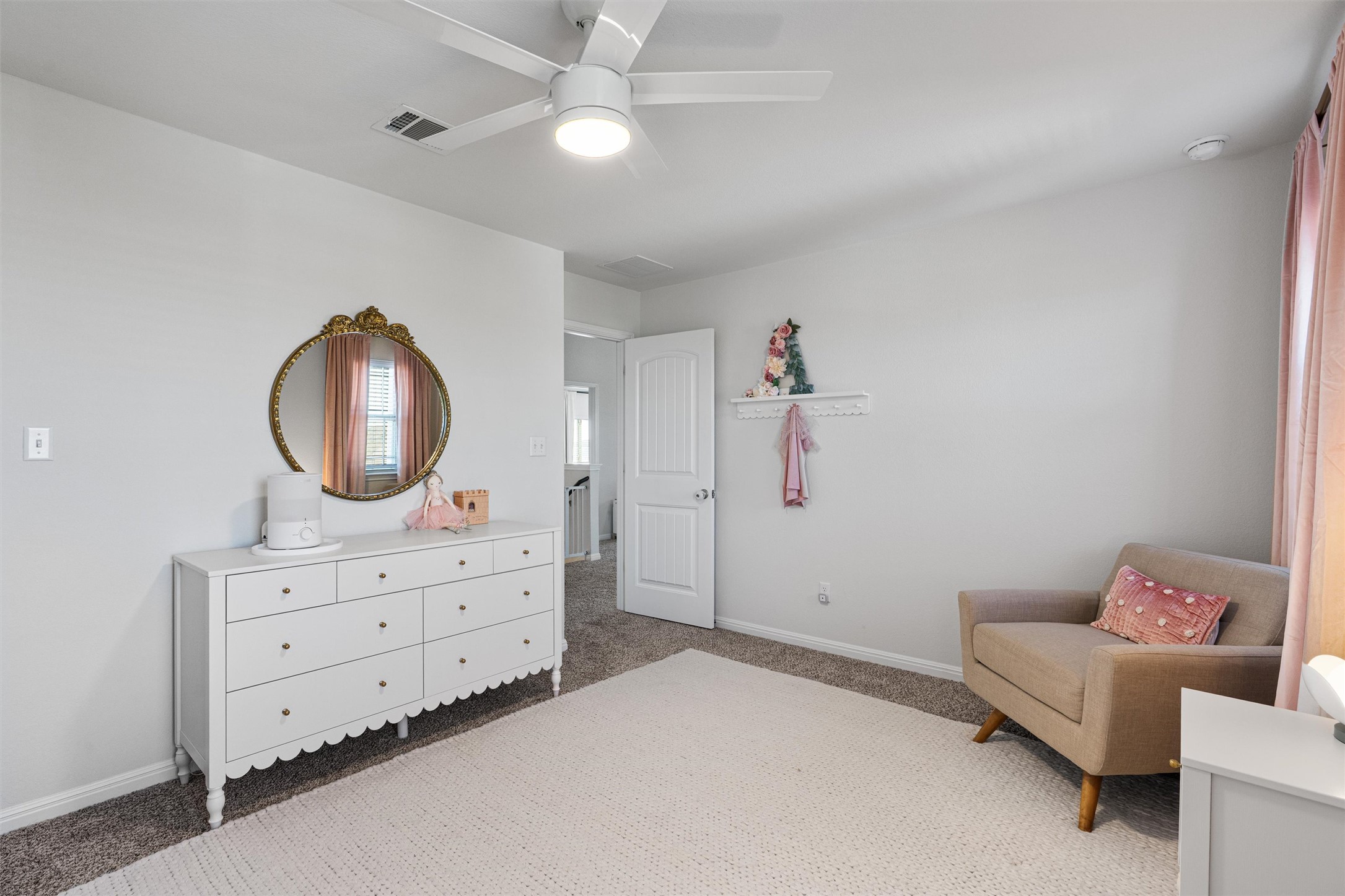 137 Red Sun Drive Kyle, TX 78640 - Photo 27 of 38 a bedroom with a baby bed and a dresser
