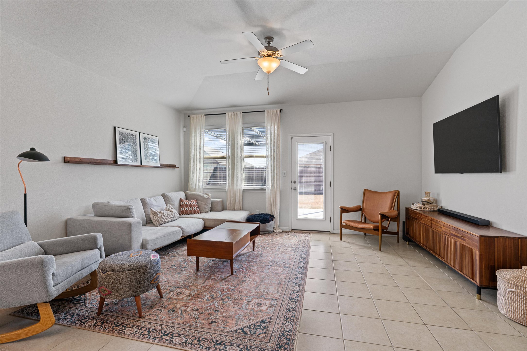 137 Red Sun Drive Kyle, TX 78640 - Photo 9 of 38 a living room with furniture and a flat screen tv