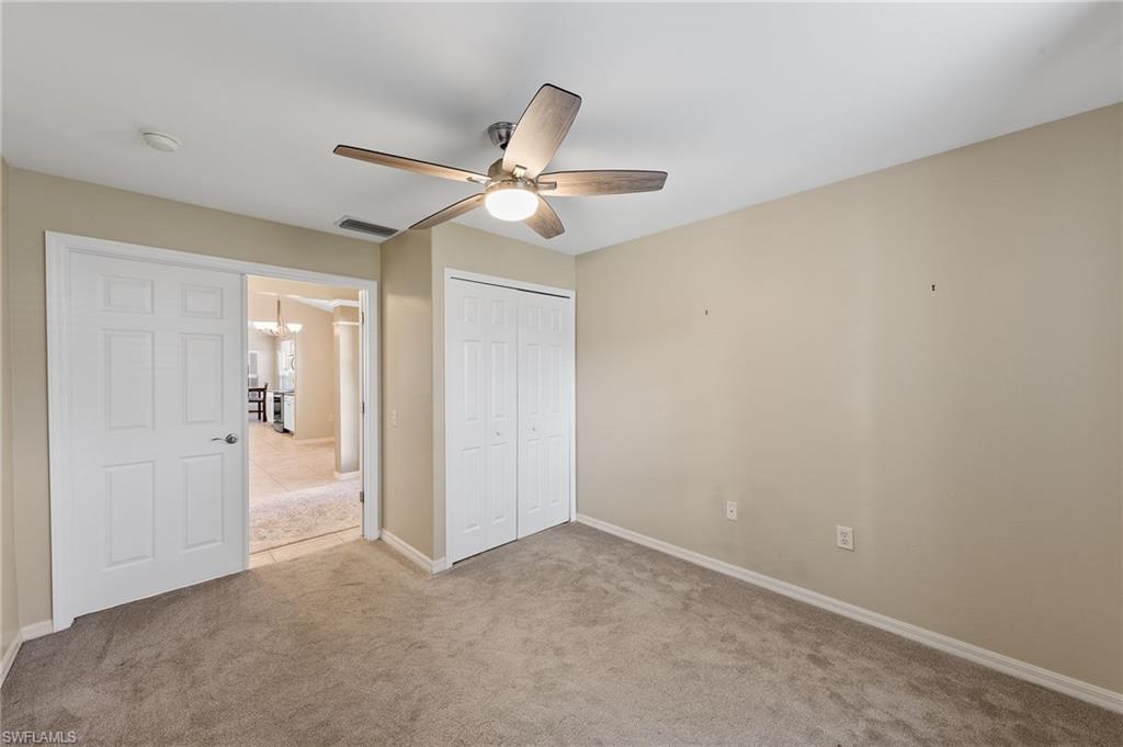 9996 Horse Creek Road Fort Myers, FL 33913 - Photo 11 of 44 an empty room with closet and a ceiling fan
