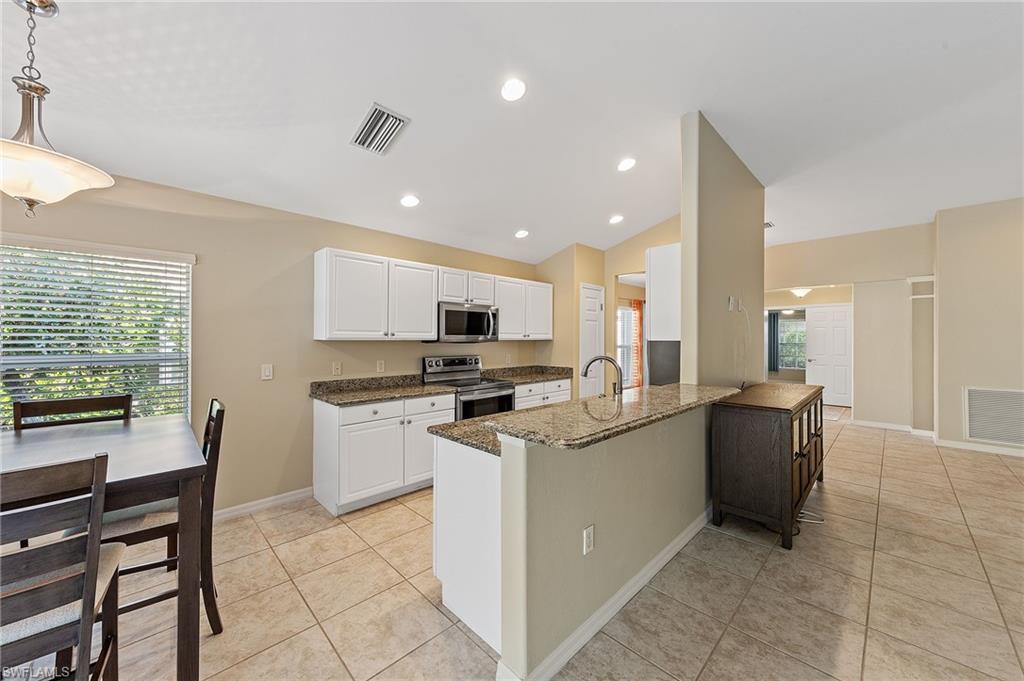 9996 Horse Creek Road Fort Myers, FL 33913 - Photo 17 of 44 a kitchen with a sink cabinets and wooden floor