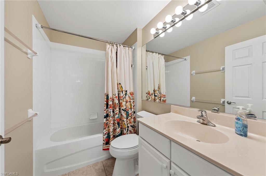 9996 Horse Creek Road Fort Myers, FL 33913 - Photo 25 of 44 a bathroom with a sink a toilet a mirror a bathtub and shower