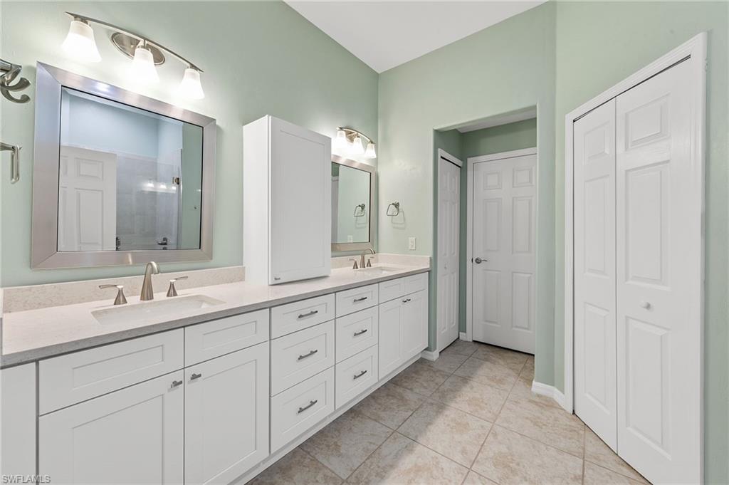 9996 Horse Creek Road Fort Myers, FL 33913 - Photo 29 of 44 a spacious bathroom with a double vanity sink and a mirror