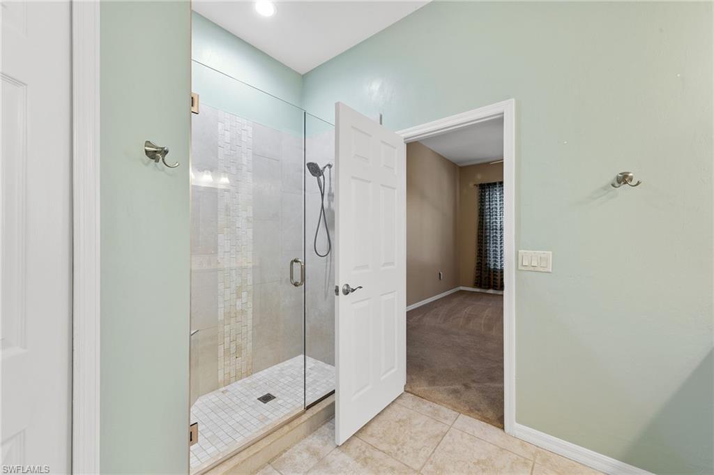 9996 Horse Creek Road Fort Myers, FL 33913 - Photo 30 of 44 a bathroom with a glass shower door