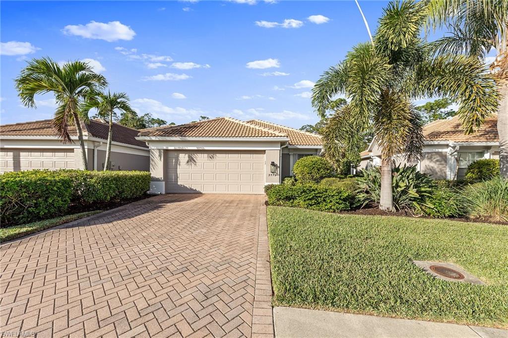 9996 Horse Creek Road Fort Myers, FL 33913 - Photo 3 of 44 a front view of a house with a garden