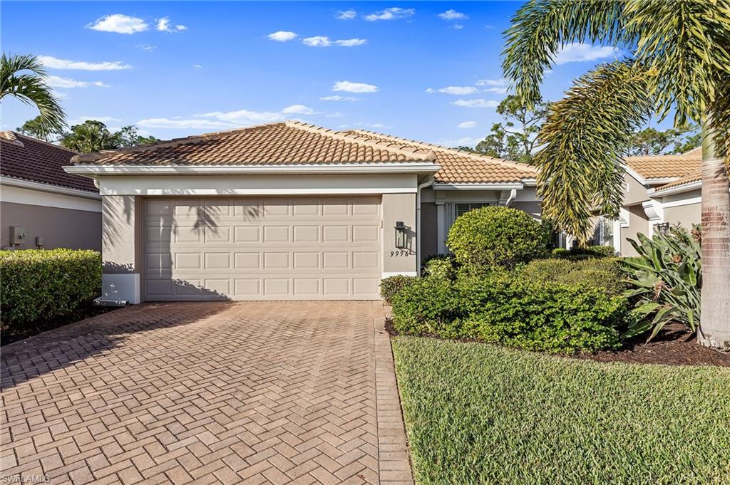 9996 Horse Creek Road Fort Myers, FL 33913 - Photo 4 of 44 a front view of a house with a garden