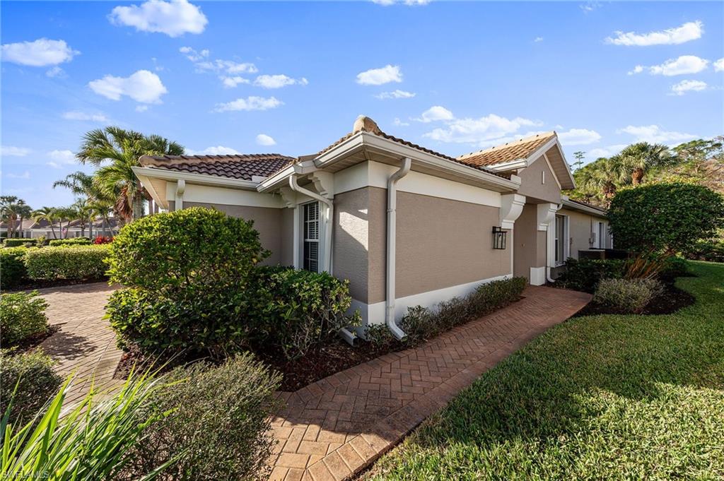 9996 Horse Creek Road Fort Myers, FL 33913 - Photo 6 of 44 a front view of a house with garden