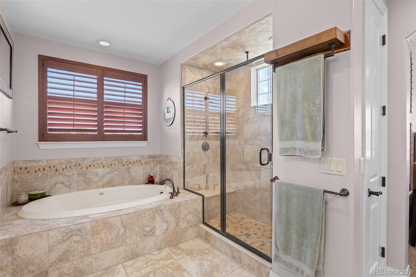 41865 East Muirfield Loop Elizabeth, CO 80107 - Photo 20 of 50 a spacious bathroom with a bathtub and shower